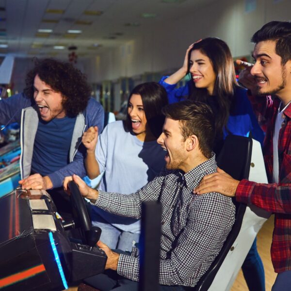 group playing arcade racing game